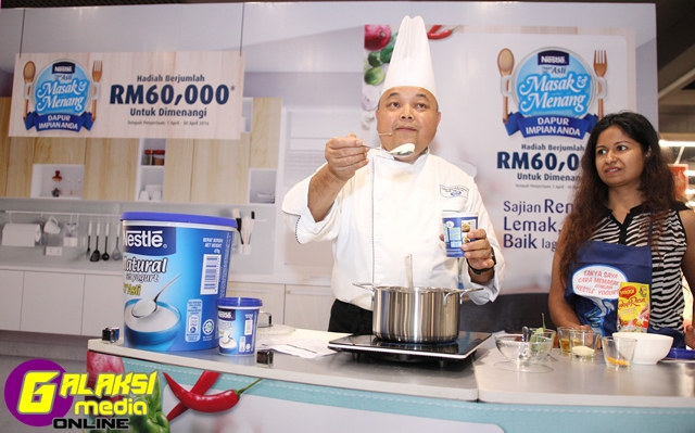 Nestle Ambassador Chef, Chef Muluk, demonstrating to a guest the use of ...