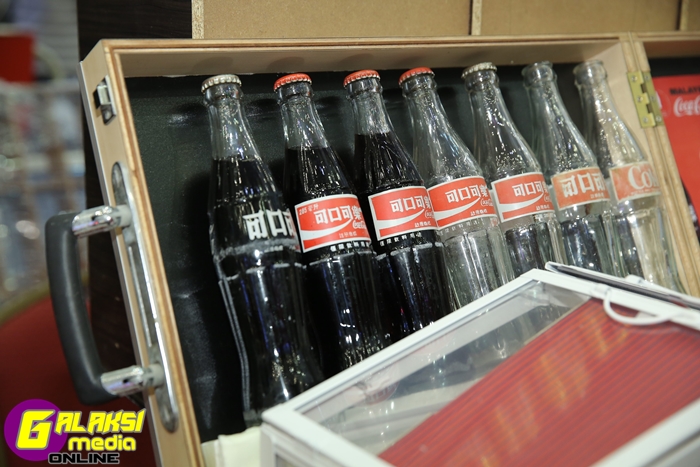 A collector displays Malaysian bottles from the past